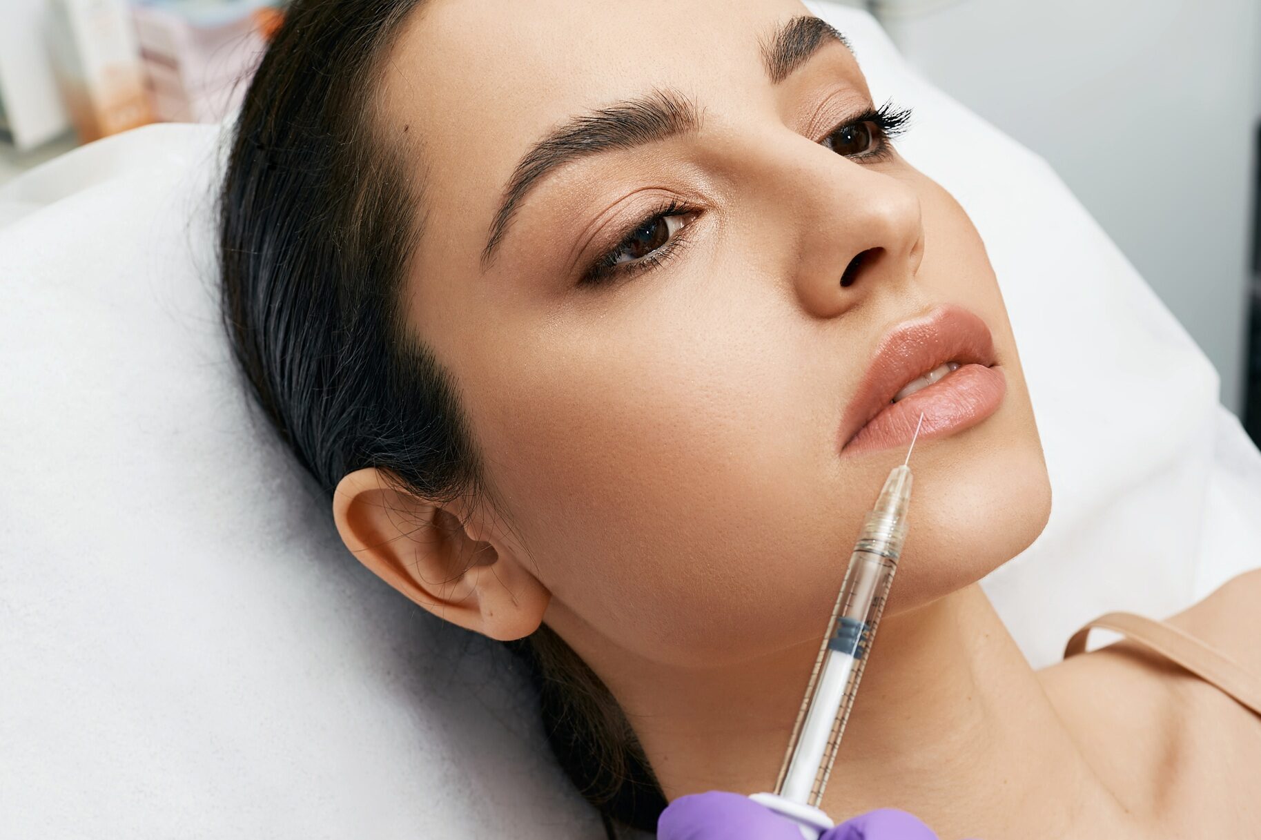 Lip augmentation procedure. Lips filler injection for beautiful woman's lip augmentation with