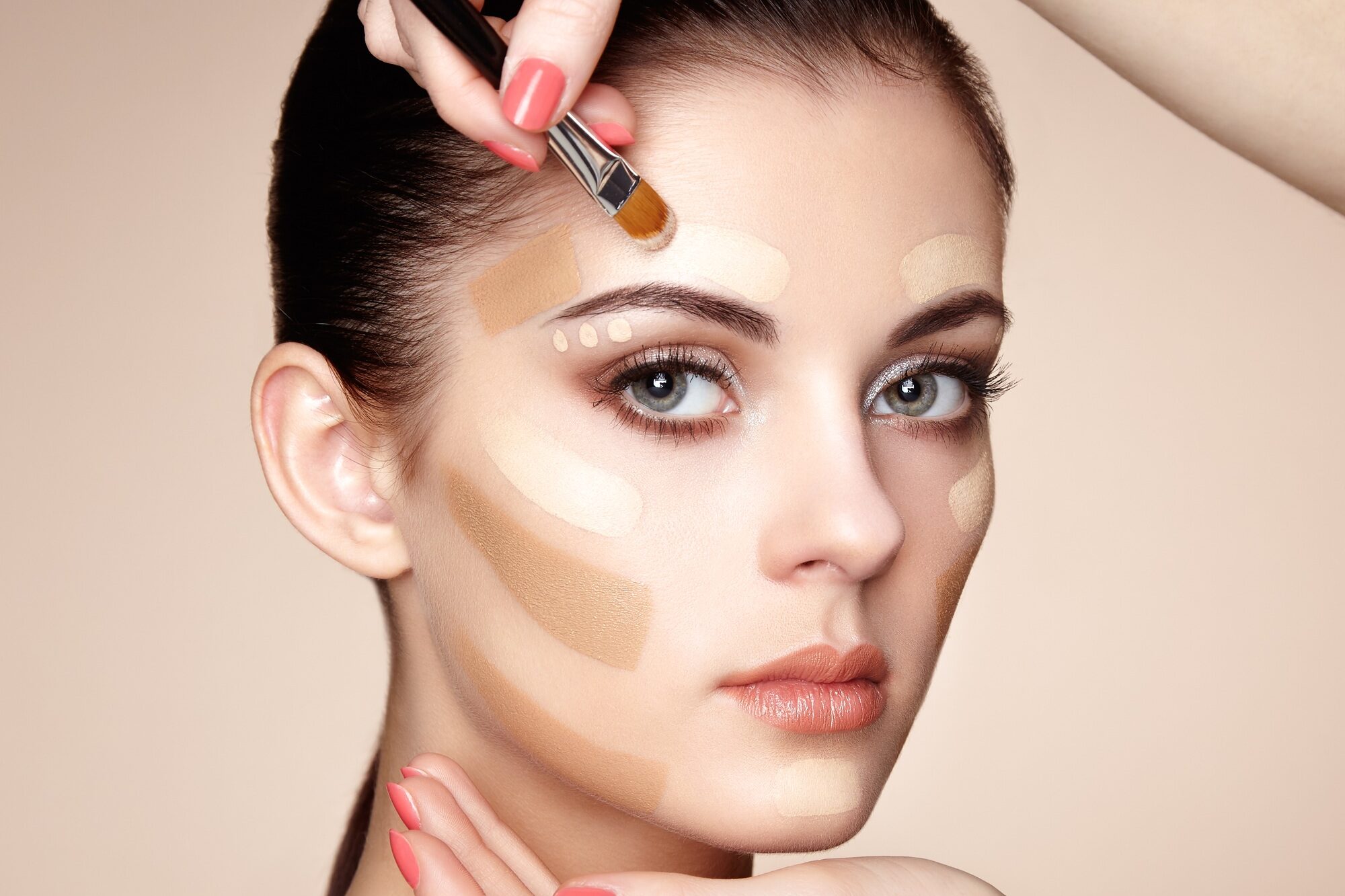 Makeup artist applies skintone